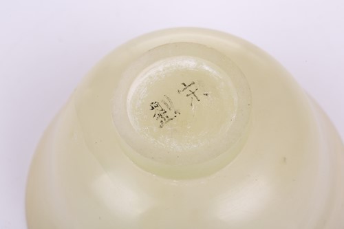 Lot 118 - A Chinese-turned translucent light green Jade...