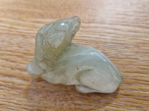 Lot 118 - A Chinese-turned translucent light green Jade...