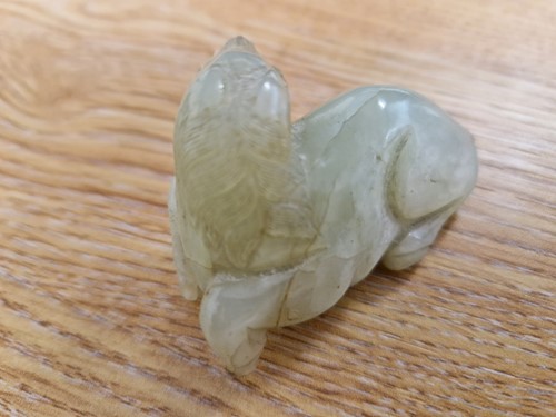 Lot 118 - A Chinese-turned translucent light green Jade...