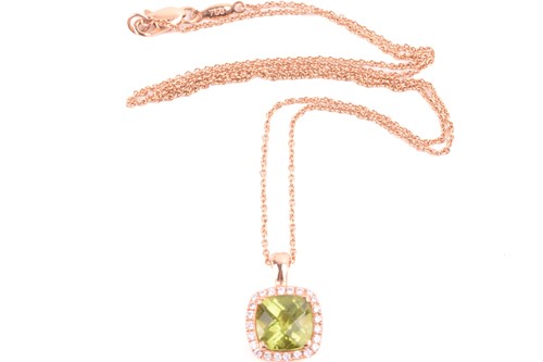 Lot 225 - A peridot and diamond cluster pendant in 18ct...