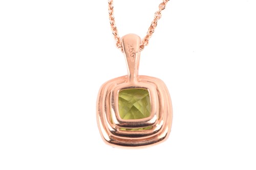Lot 225 - A peridot and diamond cluster pendant in 18ct...