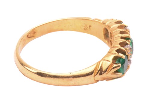 Lot 267 - An emerald and diamond half hoop ring, set...