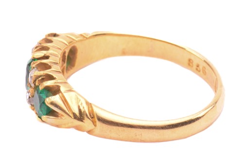 Lot 267 - An emerald and diamond half hoop ring, set...
