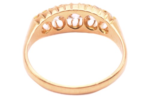 Lot 147 - A diamond ring set with a graduated row of old...