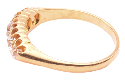 Lot 147 - A diamond ring set with a graduated row of old...