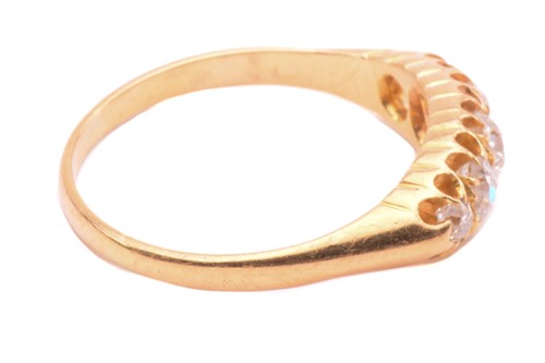 Lot 147 - A diamond ring set with a graduated row of old...