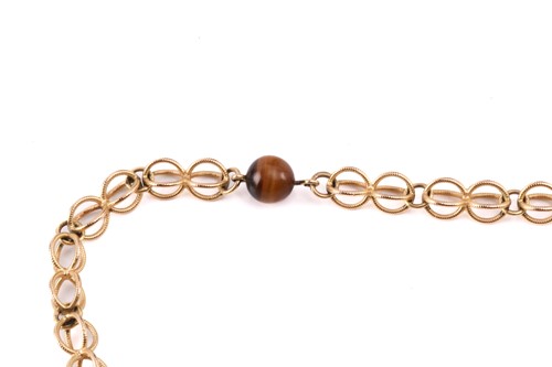 Lot 64 - A cage link necklace with tiger's eye bead...