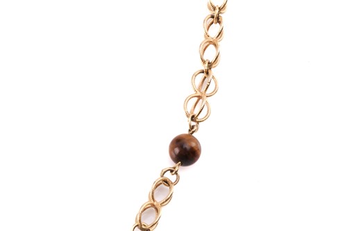 Lot 64 - A cage link necklace with tiger's eye bead...