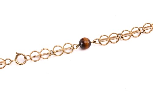 Lot 64 - A cage link necklace with tiger's eye bead...