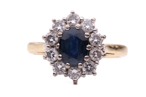 Lot 234 - A sapphire and diamond cluster ring, the...