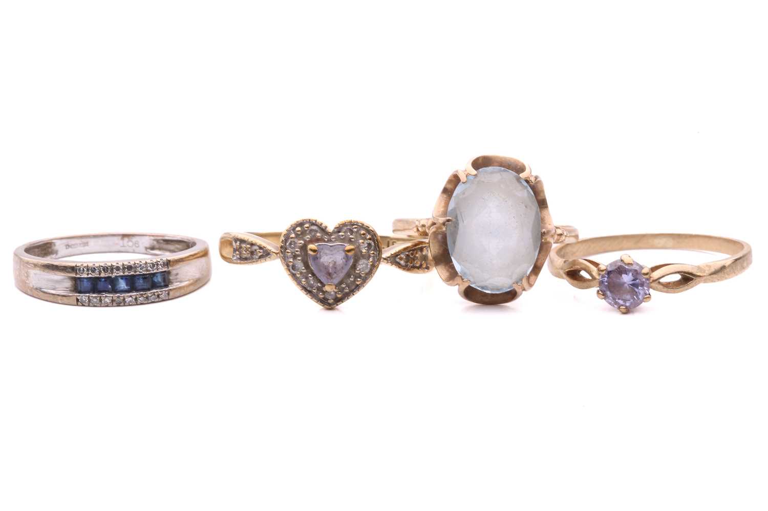 Lot 276 - A sapphire and diamond ring, set with a row of...