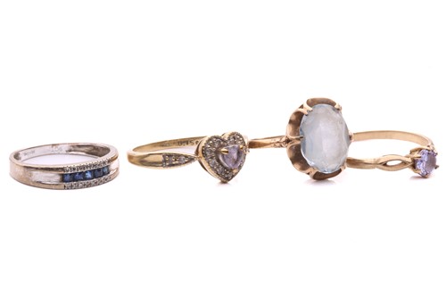 Lot 276 - A sapphire and diamond ring, set with a row of...