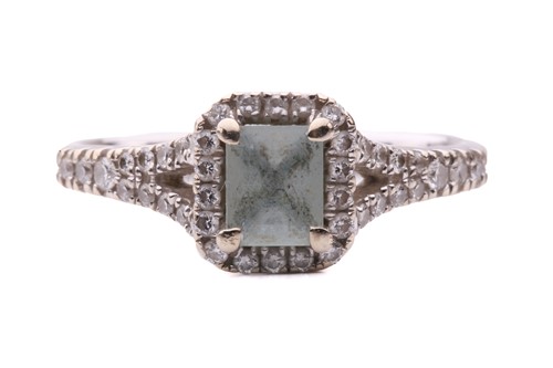 Lot 77 - An aquamarine and diamond cluster ring in 18ct...