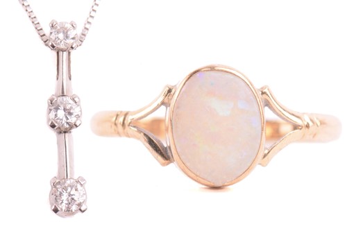 Lot 42 - An opal dress ring in 9ct gold and a diamond...