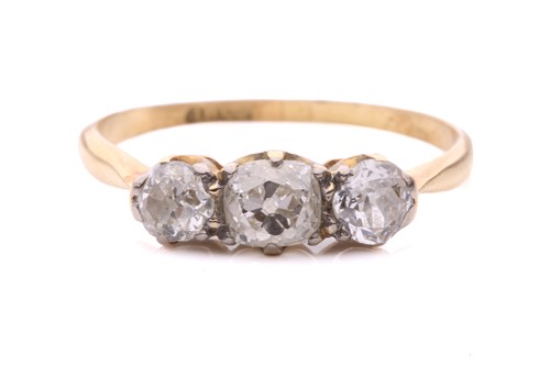 Lot 28 - A diamond three stone ring, set with a central...