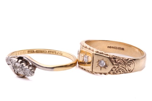 Lot 95 - A diamond three stone cross over ring set with...