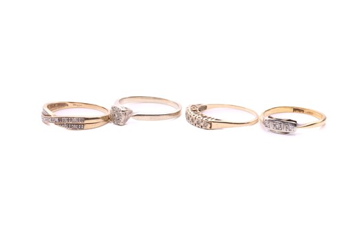 Lot 24 - Four diamond rings; a three stone ring with a...