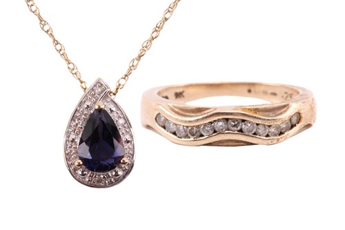 Lot 20 - An iolite and diamond drop shape pendant, the...