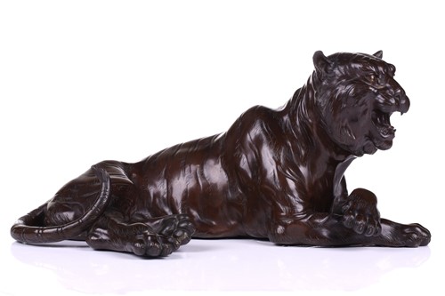 Lot 121 - A Japanese bronze figure of a recumbent tiger,...