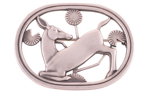 Lot 313 - Georg Jensen - a brooch depicting a kneeling...