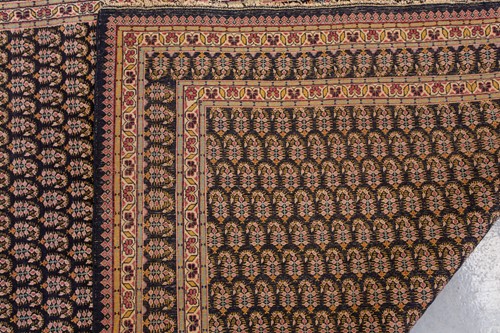 Lot 156 - A black ground Senneh rug with an allover...