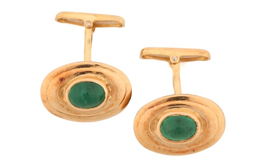 Lot 12 - A pair of emerald cufflinks, each set with an...