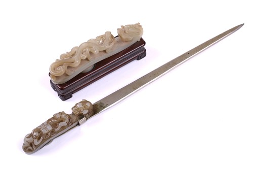 Lot 121 - A Chinese carved pale green jade belt hook,...