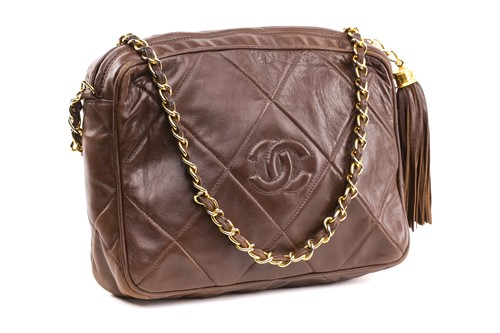Lot 27 - Chanel - a camera bag in brown quilted...