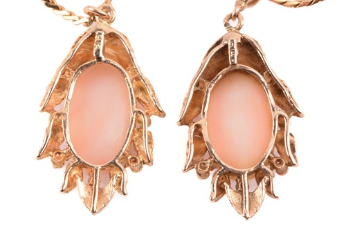 Lot 143 - Two coral-set pendants on chain together with...