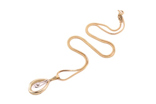Lot 76 - A drop shape pendant set with a cubic zirconia,...