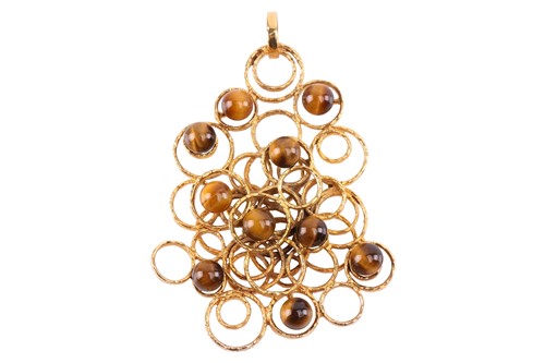 Lot 186 - A modernist tigers eye pendant, circa 1971,...