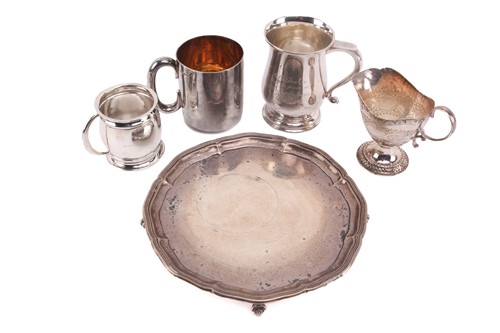 Lot 495 - A silver salver on four ball and claw feet...