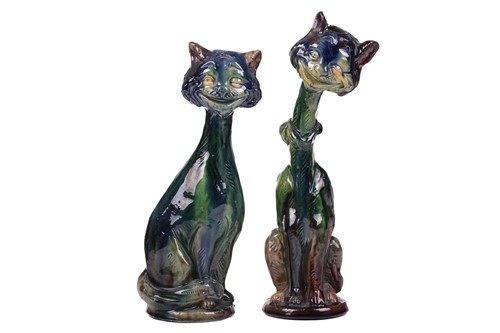 Lot 244 - A pair of earthenware winking cat candlesticks,...