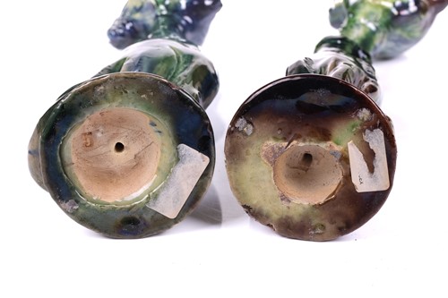 Lot 244 - A pair of earthenware winking cat candlesticks,...