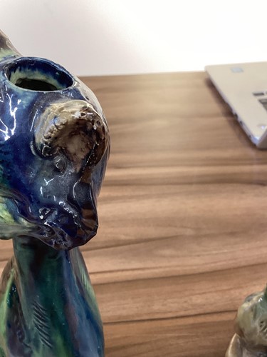 Lot 244 - A pair of earthenware winking cat candlesticks,...
