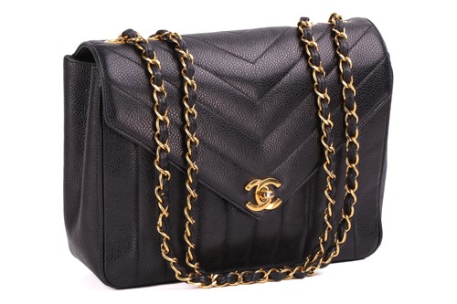 Lot 42 - Chanel - a V-stitch flap shoulder bag in black...