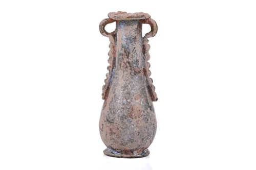 Lot 255 - A Roman glass oil flask with a pair of applied...