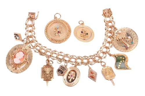 Lot 261 - A charm bracelet with a variety of charms...