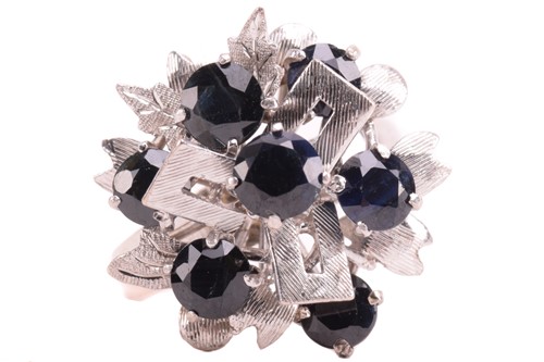 Lot 20 - A Modernist cluster ring set with sapphires,...