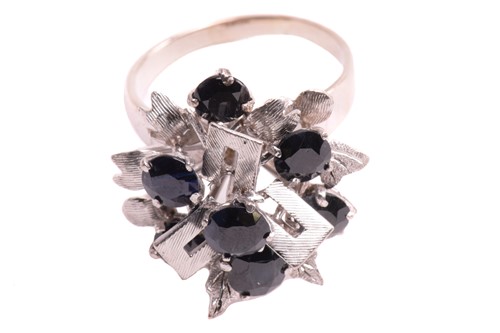 Lot 20 - A Modernist cluster ring set with sapphires,...