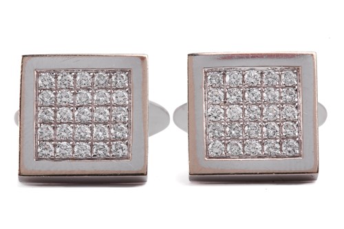 Lot 134 - A pair of diamond cufflinks, the square design...