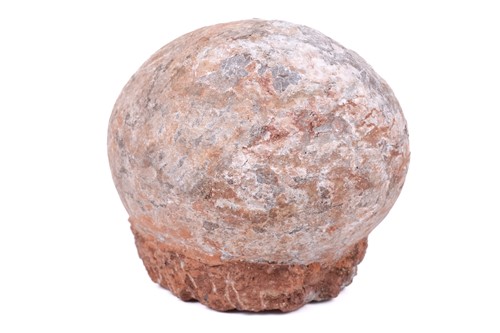 Lot 298 - A fossilised dinosaur egg, in a red stone base,...