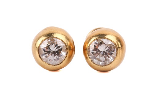Lot 56 - A pair of diamond stud earrings, each set with...