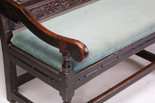 Lot 167 - An 18th century, oak settle with carved panel...