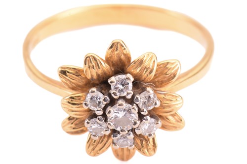 Lot 153 - A diamond flower ring, set with a central...