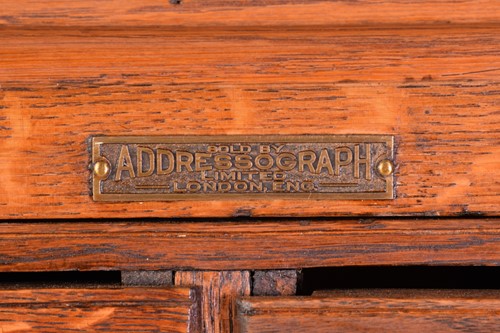 Lot 145 - An "ADDRESSOGRAPH" modular oak flight of...