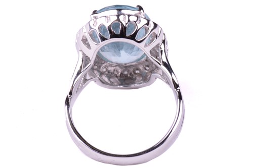 Lot 24 - An aquamarine and diamond cluster ring, set...