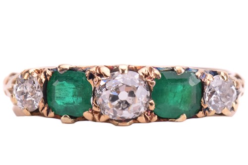 Lot 238 - An emerald and diamond five-stone carved half...