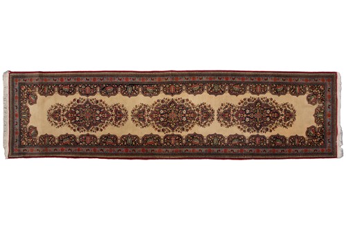 Lot 155 - An ivory ground Kerman strip runner with three...