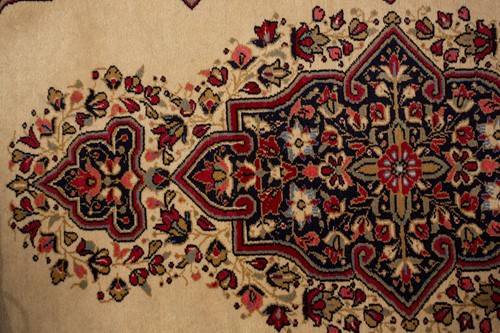 Lot 155 - An ivory ground Kerman strip runner with three...